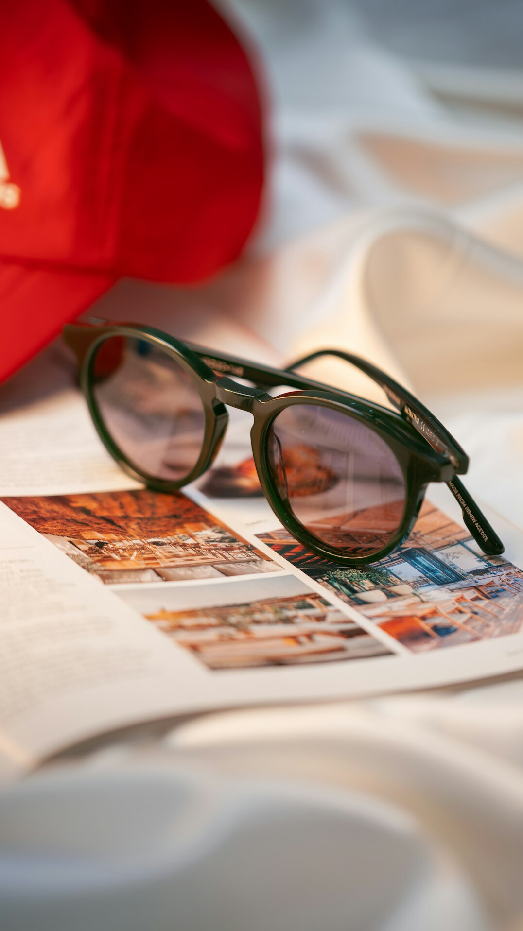 Vintage newspapers spread on a table with a pair of reading glasses