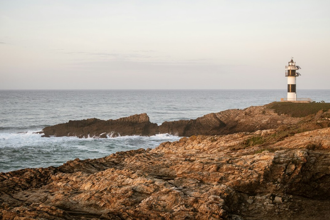 Lighthouse on the Uruguayan coast at dusk with sea mist