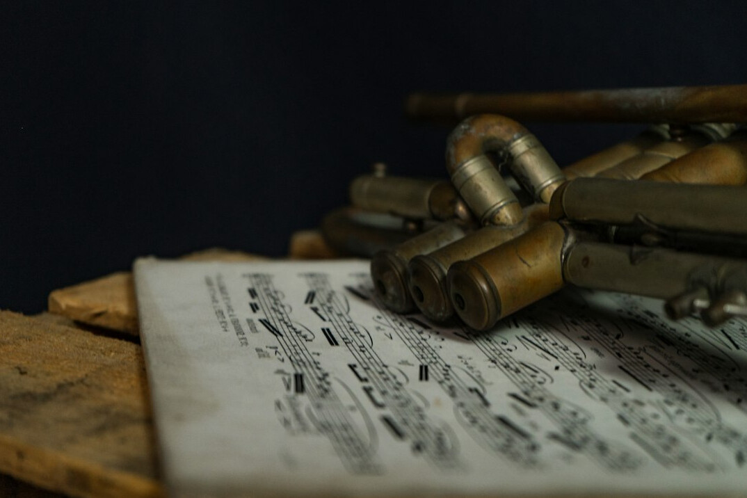 Old documents, photographs and a magnifying glass on a desk