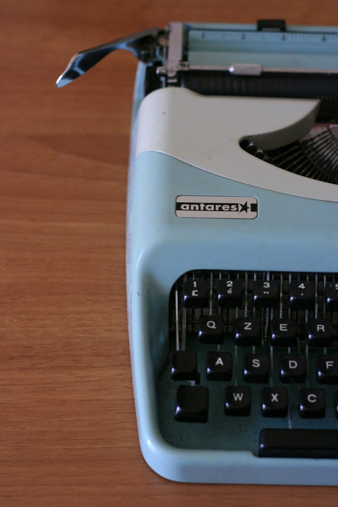 Vintage typewriter with a sheet of paper and an old brass key on a desk