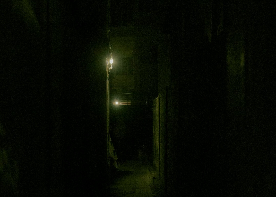 shadowy figure in dark alley