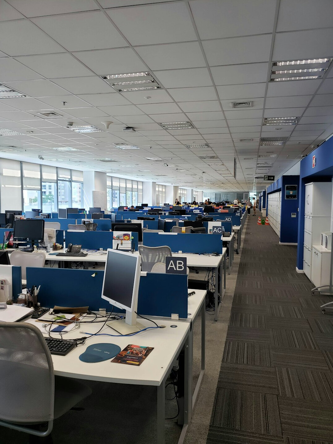 Modern newsroom with desks, monitors and a wall map